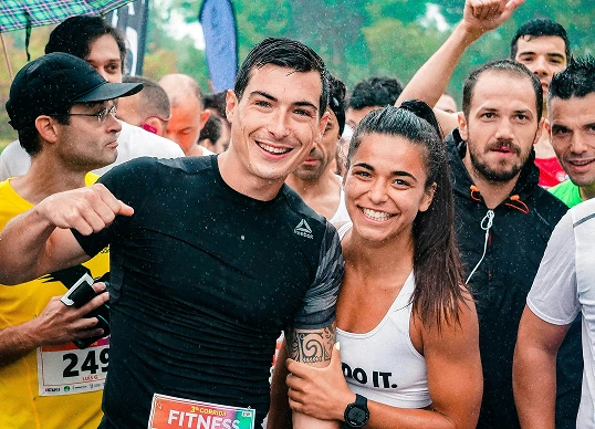 Two people smiling together at a group fitness event
